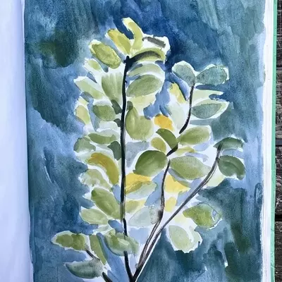 a sketchbook page of a painting of a tree. The close up painting shows the wide green curved leaves against a dark blue background 